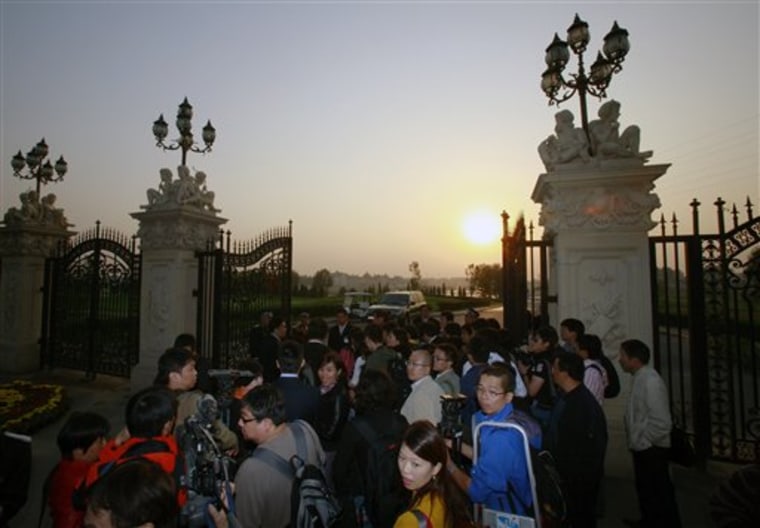 Journalists gather outside Beijing's Chateau Laffitte Castle Hotel where American investor Warren Buffett and Microsoft Corporation founder Bill Gates are attending a private dinner with China's super rich to promote philanthropy, in Beijing, China Wednesday, Sept. 29, 2010. (AP Photo/Andy Wong)